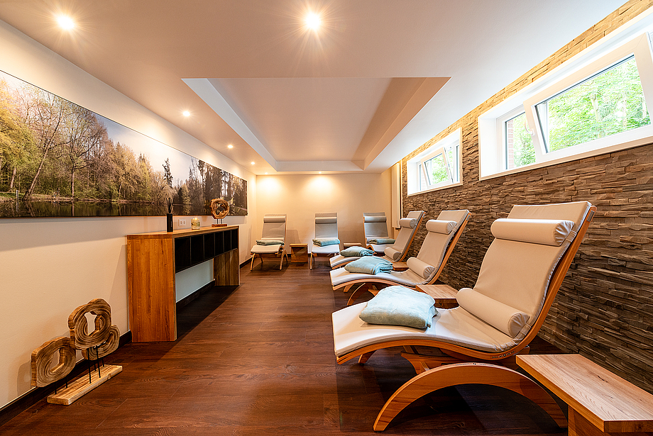 Relaxing loungers in a room with forest pictures on the wall