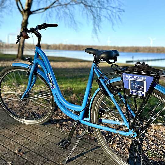 Blue bike in front of a lake
